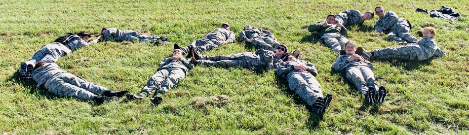 Cadets spelling out CAP on a field of grass